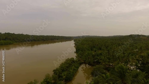 Aerial view of river and village with coconut trees. photo