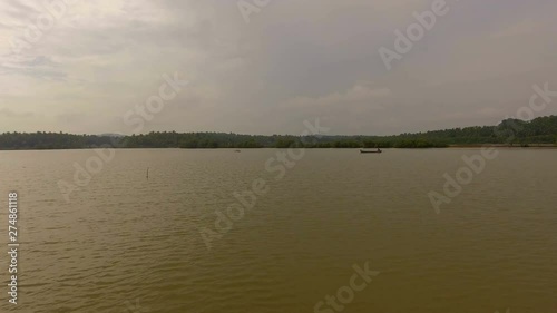 Distant aerial shot of fisherman on river fishing. photo