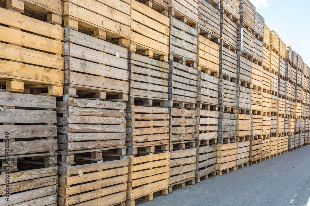 rows of wooden crates boxes and pallets for fruits and vegetables in storage stock. production warehouse. Plant Industry rows of wooden crates boxes and pallets for fruits and vegetables in storage stock. production warehouse. Plant Industry