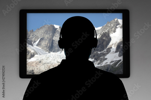 man silhouette with earphone wacht television with copy space for your text photo