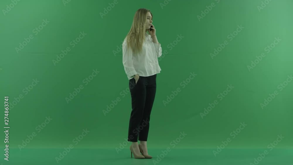 Young blond attractive woman talks on cellphone, chroma key, green background Young blond attractive woman talks on cellphone, chroma key, green background