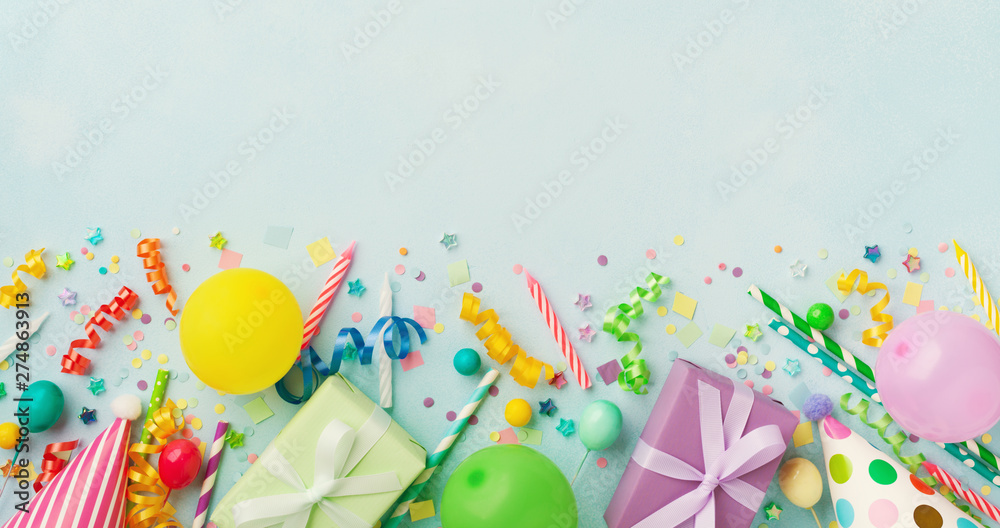 Holiday background with balloons, gift boxes and confetti. Birthday and party supplies on blue table top view. Banner format. - obrazy, fototapety, plakaty 