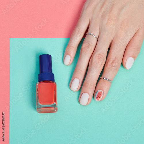 Cosmetics hand makeup  beautiful nails manicure  nail Polish  advertising on colored paper background. Fingers with bright colored manicure