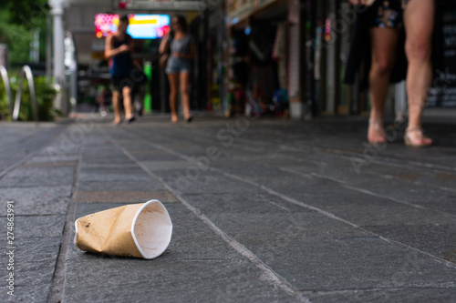 Disposable cup littered on sidewalk