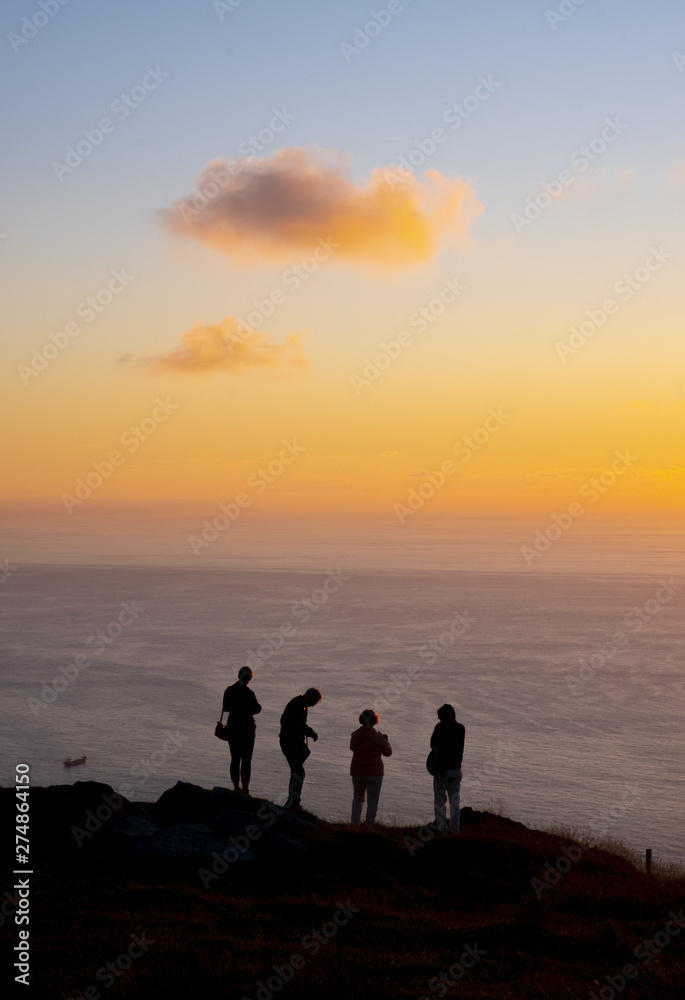 silhouettes of people on top of the mountain at dusk, Basque Country silhouettes of people on top of the mountain at dusk, Basque Country