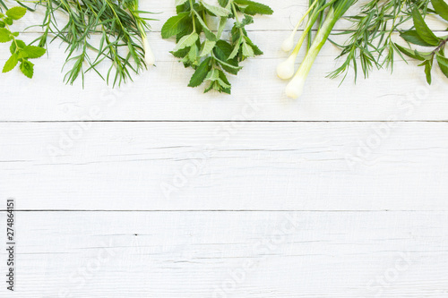 White wooden background with fresh herbs