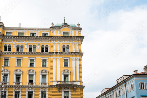 yellow building with white windows in Rijeka, Croatia