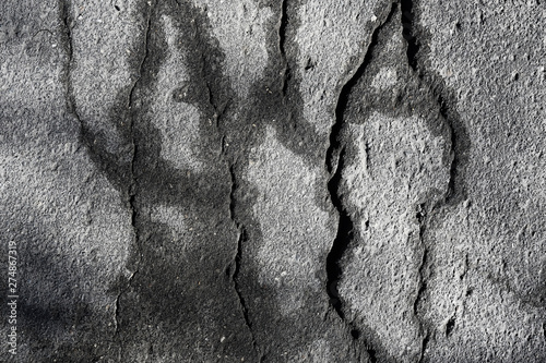 asphalt in cracks texture / abstract background cracks on asphalt road