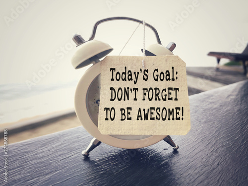Motivational and inspirational wording - Today’s Goal: Don’t Forget To Be Awesome written on a paper. Blurred styled background.