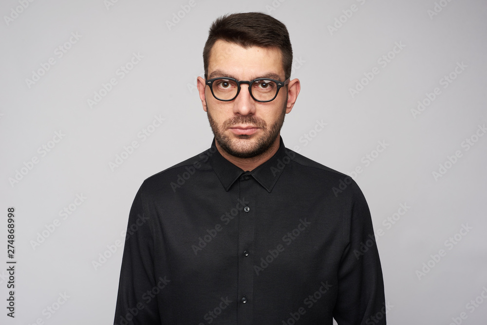bearded young bsinessman is wearing eyeglasses isolated bearded young bsinessman is wearing eyeglasses isolated