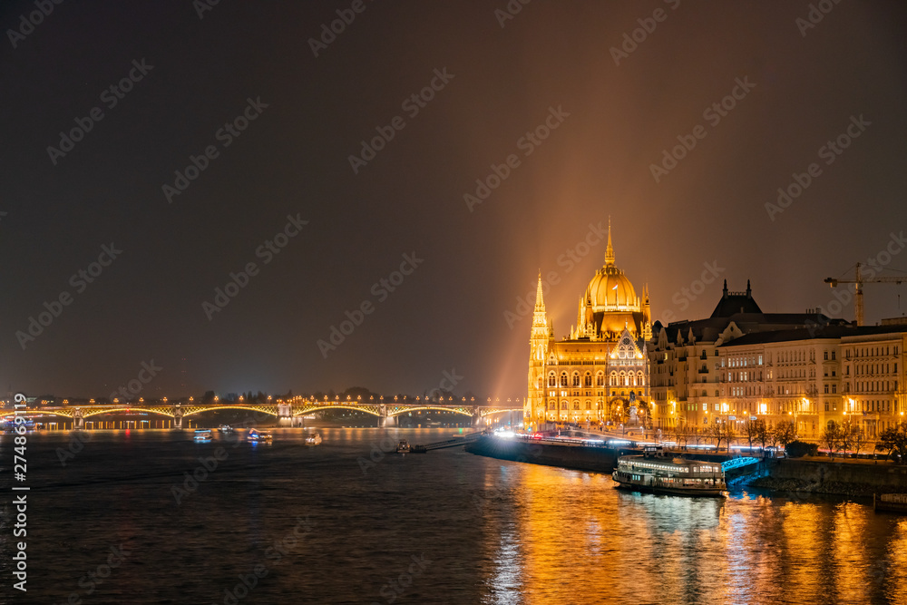 Night view of the Hungarian Parliament Building and River Danube bank