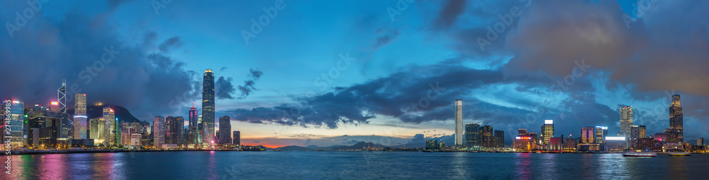Panorama of Skyline and harbor of Hong Kong city at dusk