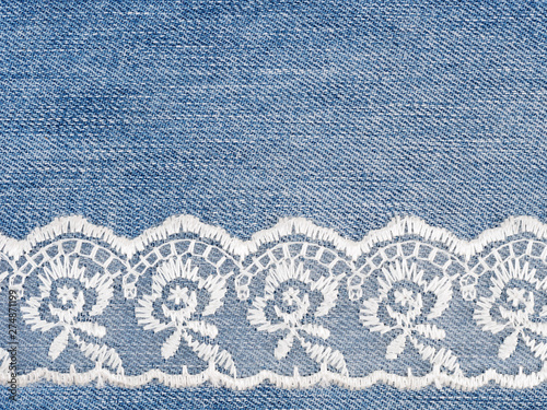 White lace on jeans background. Sewing still life photo