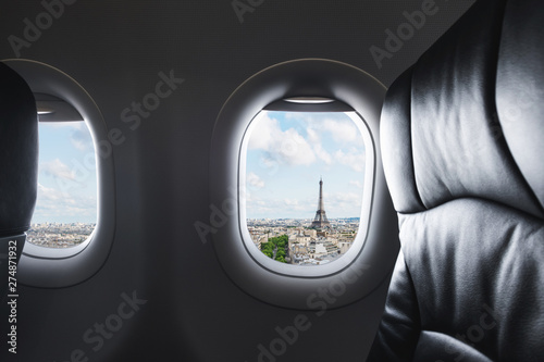 Traveling Paris, France famous landmark and travel destination in Europe. Aerial view Eiffel Tower through airplane window