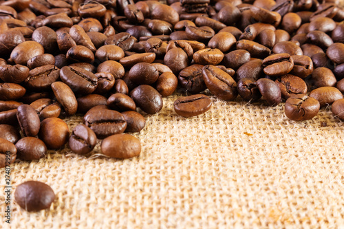Coffee beans on a background of burlap. Place for text. Concept of making coffee  coffees.