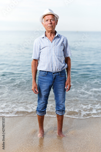 Portrait of positive mature man near the sea