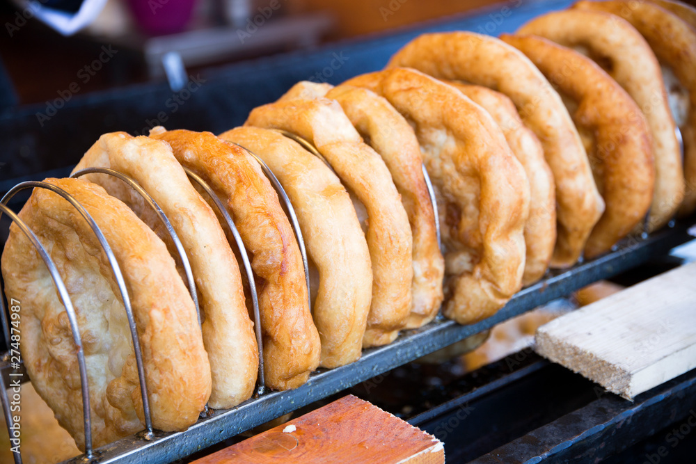 Langos is the hungarian traditional fried dough pie - obrazy, fototapety, plakaty 