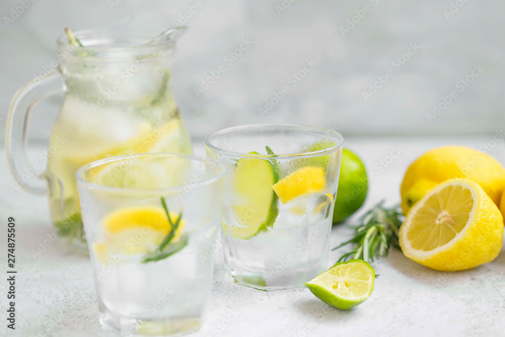 Lime, lemon , rosemary lemonade with ice cubes, refreshing summer drink Lime, lemon , rosemary lemonade with ice cubes, refreshing summer drink
