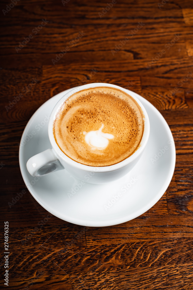 cup of cappuccino on the wooden background cup of cappuccino on the wooden background