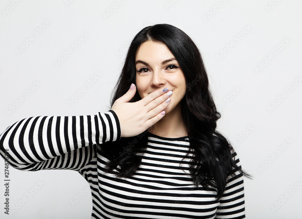 shocked woman keeps mouth widely opened, looks at camera, wears casual clothes. shocked woman keeps mouth widely opened, looks at camera, wears casual clothes.