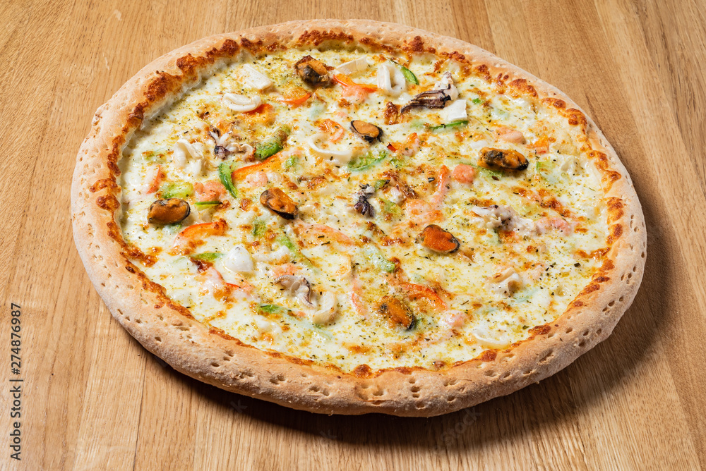 italian pizza on the wooden background italian pizza on the wooden background