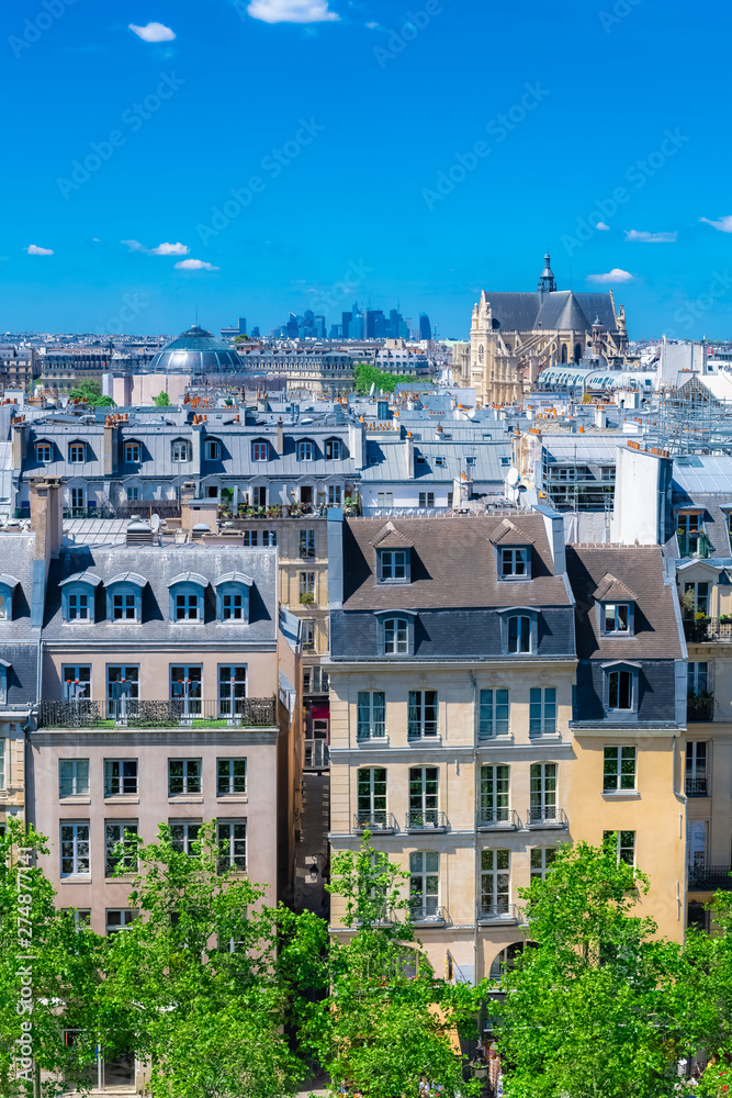 Paris, typical roofs in the Marais, aerial view with the Saint-Eustache church and the Defense in background 