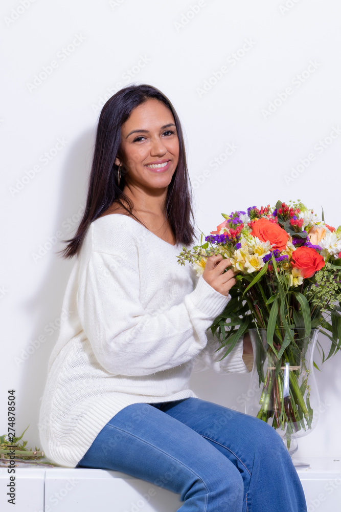 Cute brunette woman enjoying her bouquet of flowers Cute brunette woman enjoying her bouquet of flowers