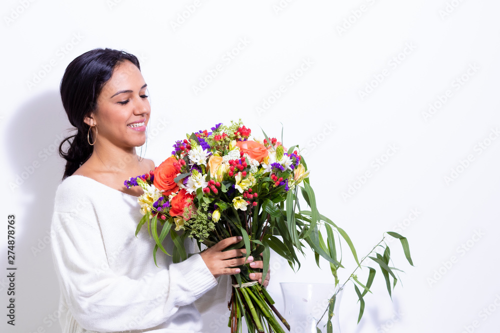 Cute brunette woman enjoying her bouquet of flowers Cute brunette woman enjoying her bouquet of flowers