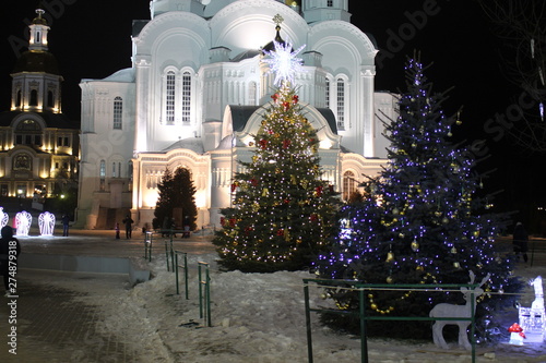 dekorated christmas tree near the churchon the night before christmas photo