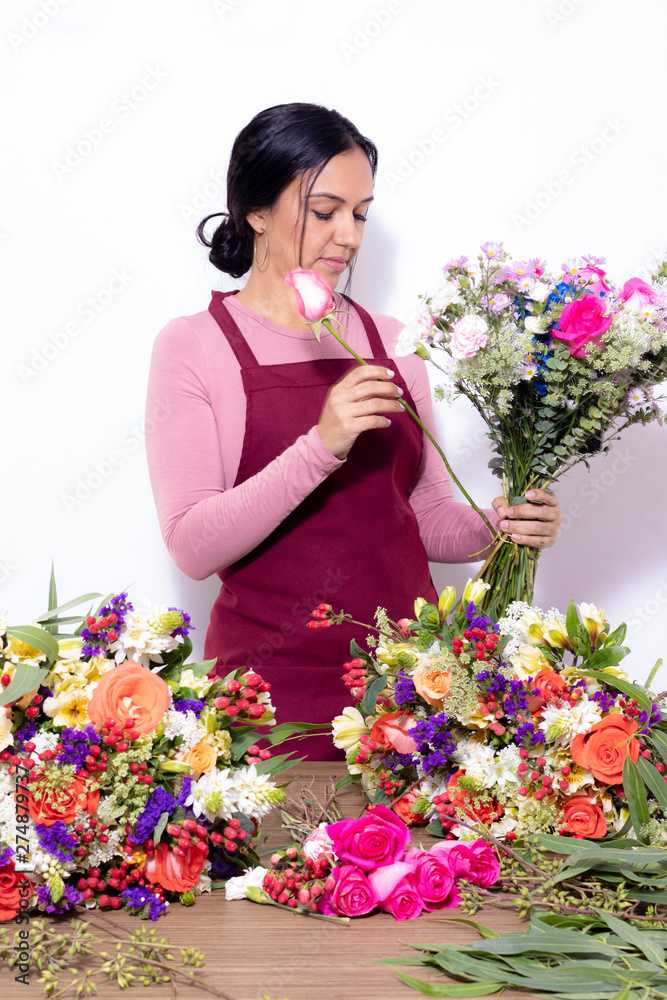 Brunette woman making bouquets at the florist shop Brunette woman making bouquets at the florist shop