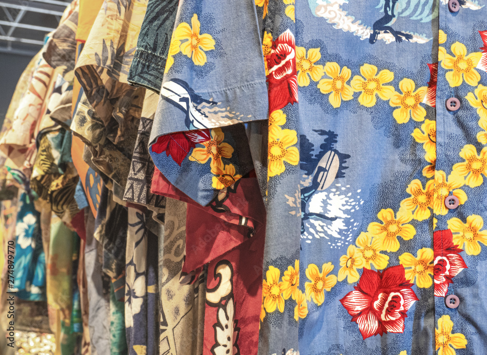 Milan - Italy. Hawaiian shirts with flowers and surf scenes, ideal for wearing on the beach.For sale at the flea market