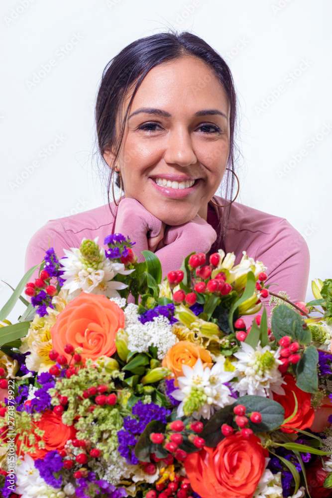 Cute brunette woman enjoying her bouquet of flowers Cute brunette woman enjoying her bouquet of flowers
