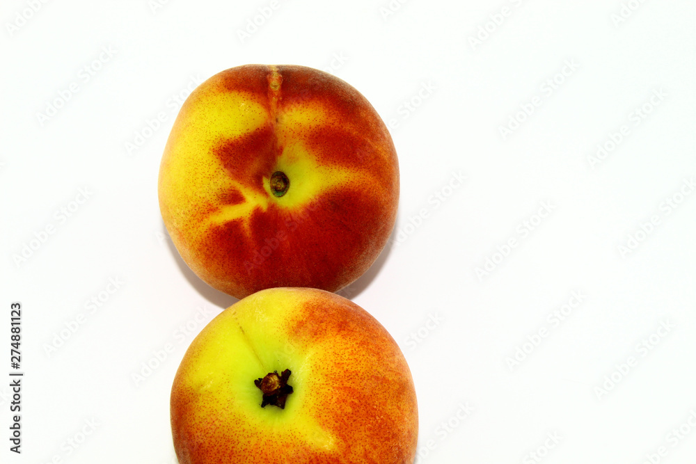 On a white background two peaches fresh and juicy On a white background two peaches fresh and juicy
