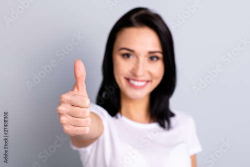 Close up photo beautiful amazing she her lady hand arm thumb raised up perfect ideal appearance cheerful mood agreement opinion tested product wear casual white t-shirt isolated bright grey background