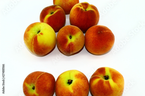 Nine fresh peaches on white background