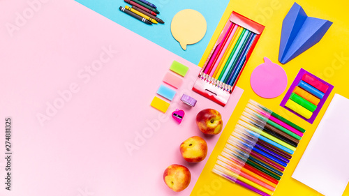 School supplies, colorful stationery, backpack and lunchbox with funny food for kids . Back to school concept lay out