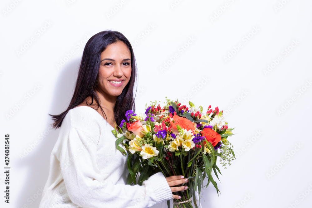 Cute brunette woman enjoying her bouquet of flowers Cute brunette woman enjoying her bouquet of flowers