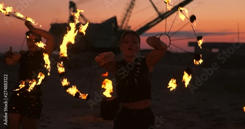 Fire show artist breathe fire in the dark at abandon building, slow motion. Fire in heart shape
