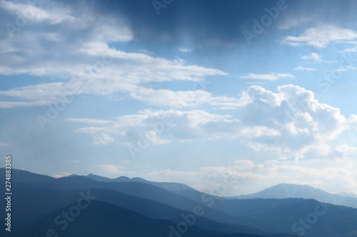 Mountains view and blue sky with clouds on background. © Natia