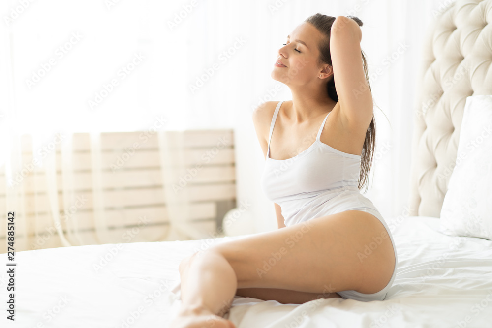Lovely woman posing in a bedroom