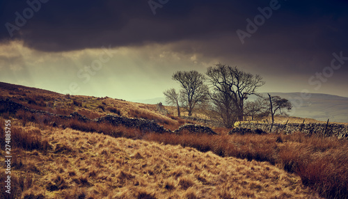 Obraz na plátně Dark storm clouds and rays of sunshine over the Yorkshire Dales near Horton in Ribblesdale