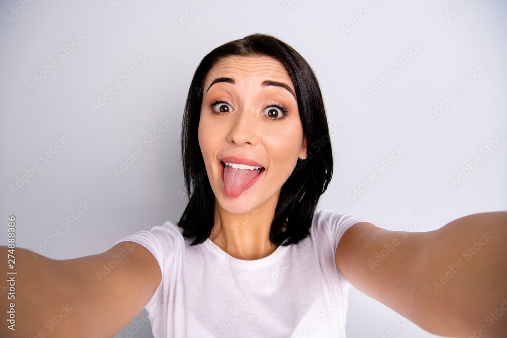 Self-portrait of her she nice-looking attractive lovely shine charming cheerful cheery glad crazy funky girl having fun showing tongue out isolated over light gray pastel background Self-portrait of her she nice-looking attractive lovely shine charming cheerful cheery glad crazy funky girl having fun showing tongue out isolated over light gray pastel background