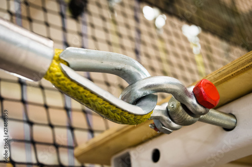 Obraz na płótnie fastening a yellow nylon rope to a metal structure close-up. equipment in the obstacle course w salonie