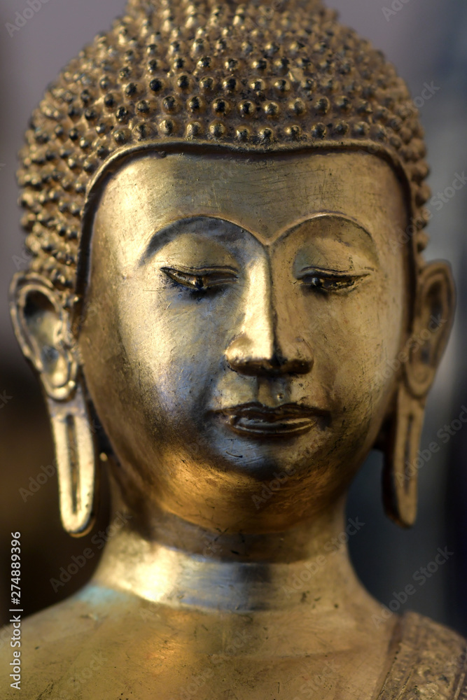 The face of the golden Buddha statue in the temple
