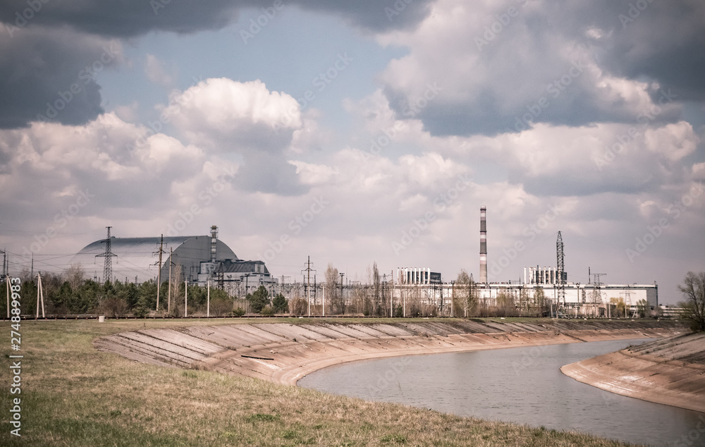fourth block of Chernobyl nuclear power plant with new Arch shelter built in 2016 and cooling pond