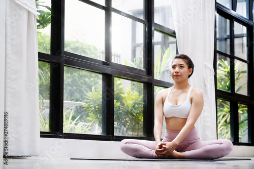 Yoga activities of Asian women Can play inside the house And play at any time For good health and weight loss in order to have beautiful shape Suitable for people of all ages Good health care concept