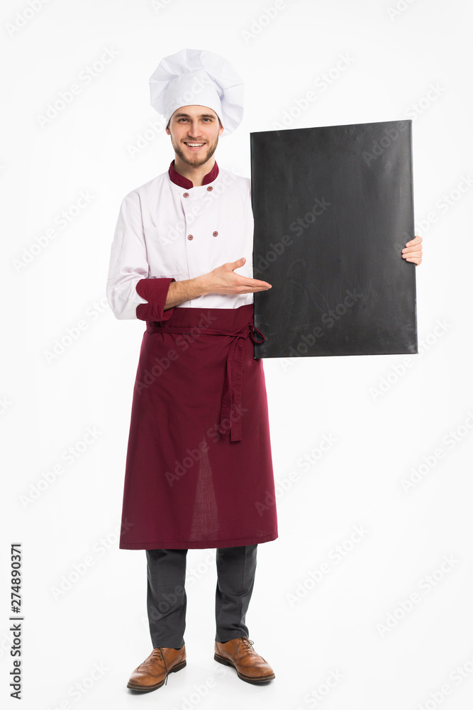 Full length portrait of a cheerful male chef cook in uniform holding blank board isolated on a white background. Full length portrait of a cheerful male chef cook in uniform holding blank board isolated on a white background.