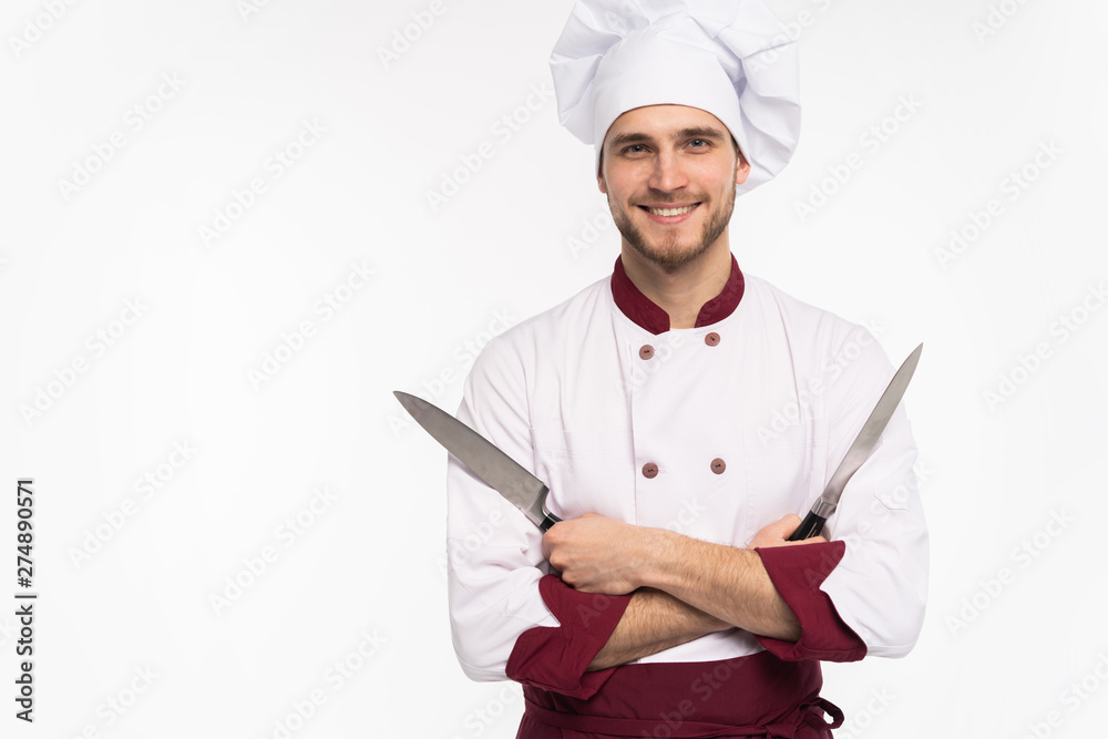Portrait of a handsome male chef cook holding knifes isolated on a white background Portrait of a handsome male chef cook holding knifes isolated on a white background