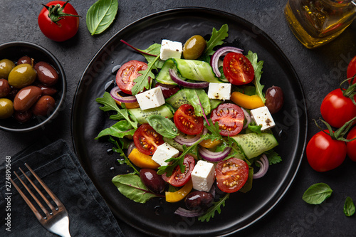 Obraz na plátně salad with tomato, cucumber, bel pepper , olives and feta cheese on black plate