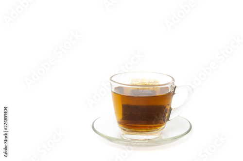 Tea bag in a glass cup isolated in white background.